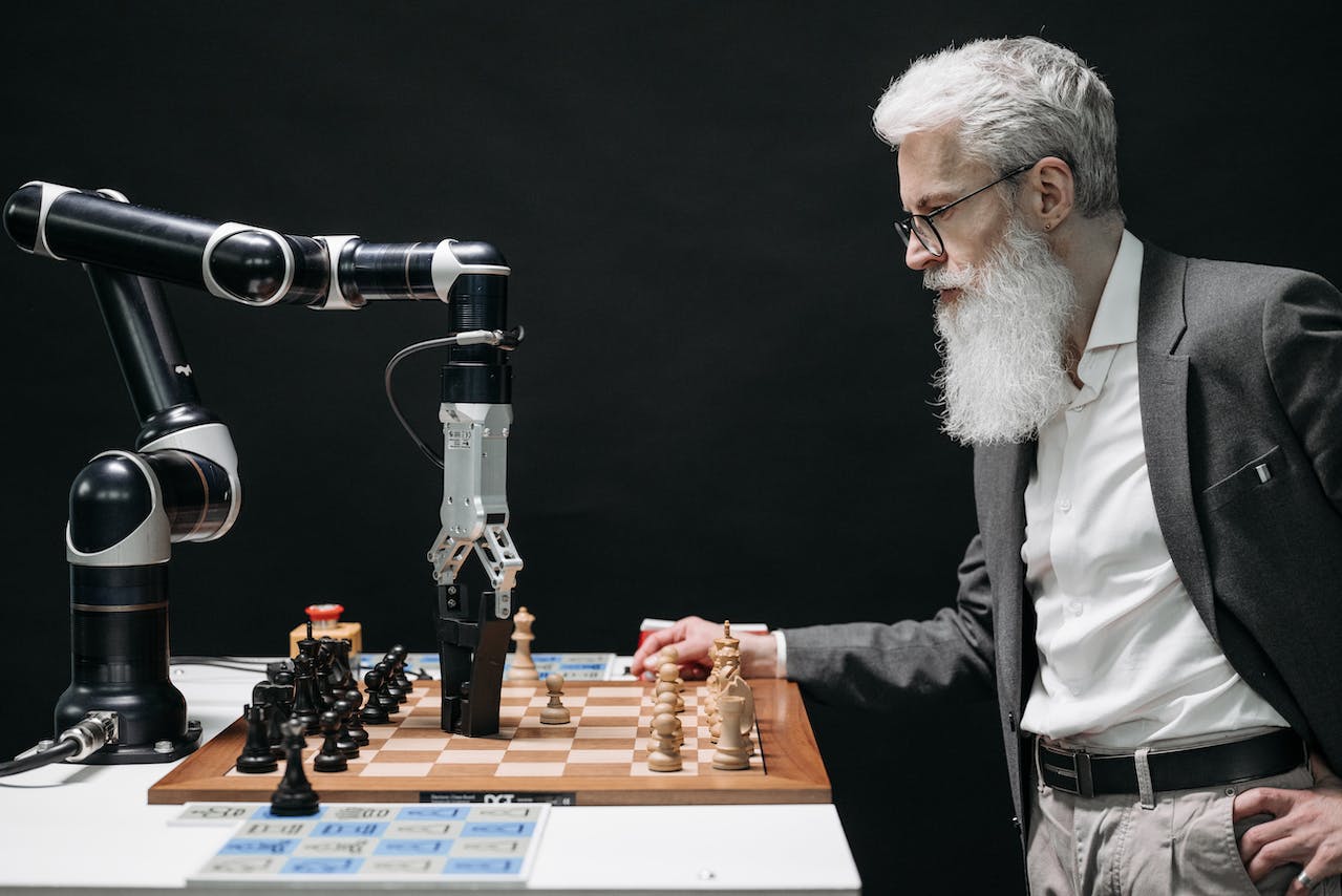 A man playing chess with a robot